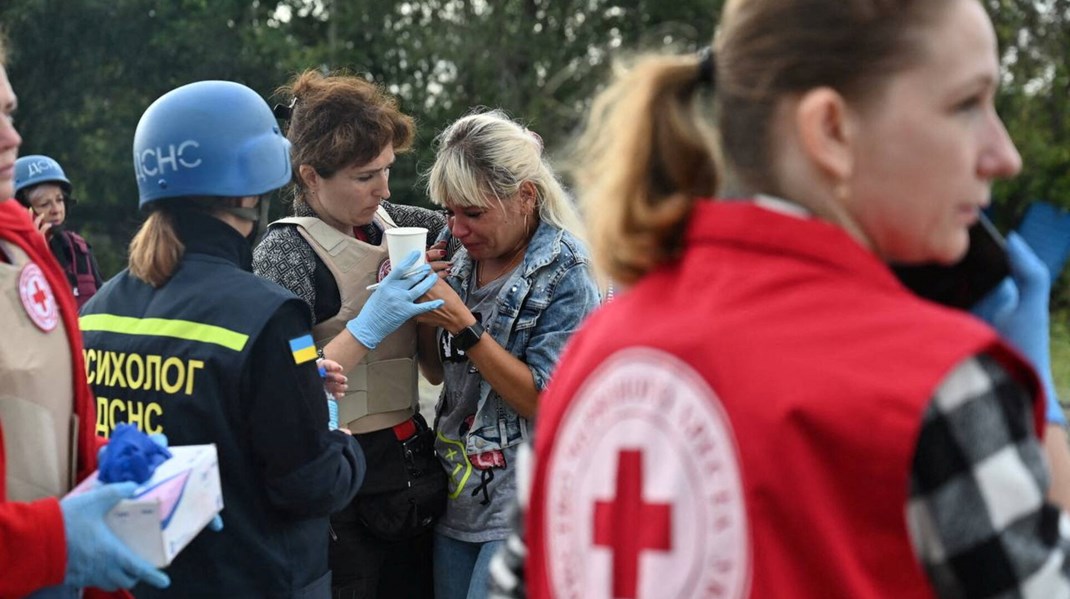 En kvinde får krisehjælp af psykologer oven på et russisk missilangreb mod en konvoj af civile biler i Zaporizjzja i det sydlige Ukraine 30. september 2022.